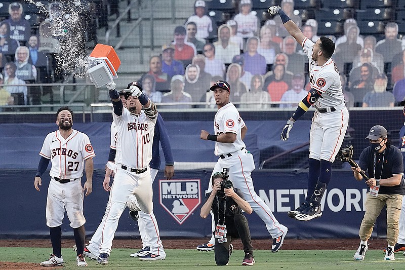 Carlos Correa (right) and his Astros teammates celebrate his walk-off home run to end Thursday's Game 5 of the ALCS against the Rays in San Diego.