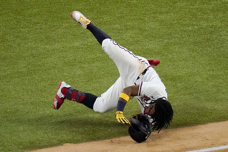 Ronald Acuna Jr. of the Braves falls at first base during the sixth inning of Thursday night's Game 4 of the National League Championship Series against the Dodgers in Arlington, Texas.