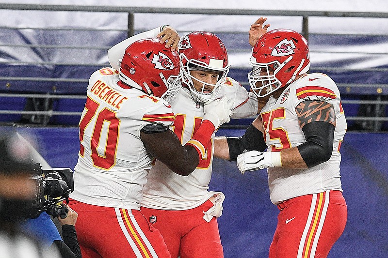 Chiefs offensive guard Kelechi Osemele (left), quarterback Patrick Mahomes and offensive tackle Mike Remmers celebrate Mahomes' touchdown during a game against the Ravens earlier this season in Baltimore. Osemele will miss the remainder of the season with an injury and will be replaced by Remmers in the starting lineup.