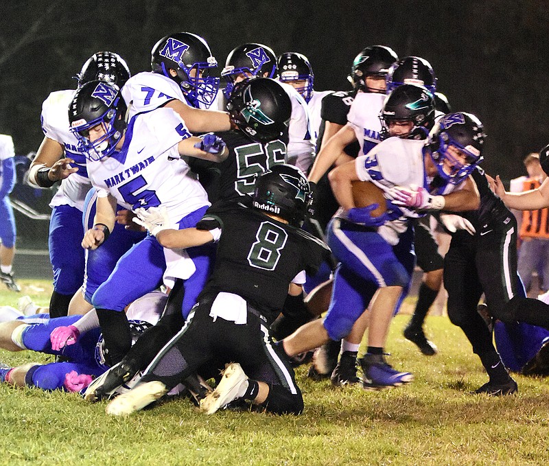 The North Callaway defense tries to bring down Mark Twain junior running back Landon Moss (34) during the Thunderbirds' 47-12 EMO rout of the Tigers on Friday night at Kingdom City.