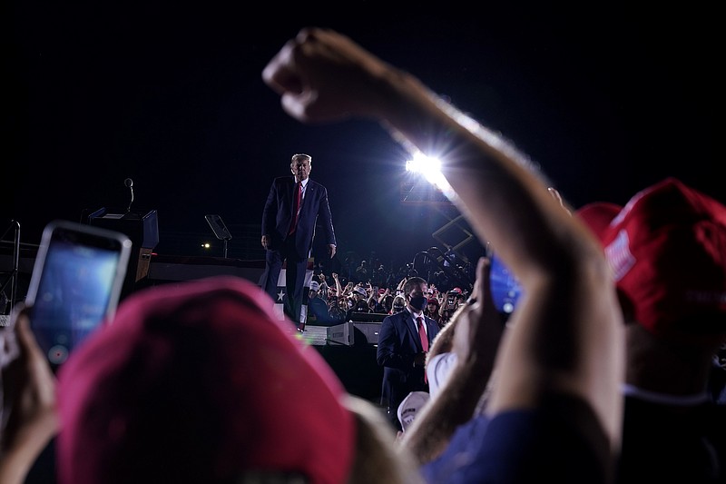 Supporters cheer as President Donald Trump leaves after speaking at a campaign rally at Middle Georgia Regional Airport, Friday, Oct. 16, 2020, in Macon, Ga. (AP Photo/Evan Vucci)