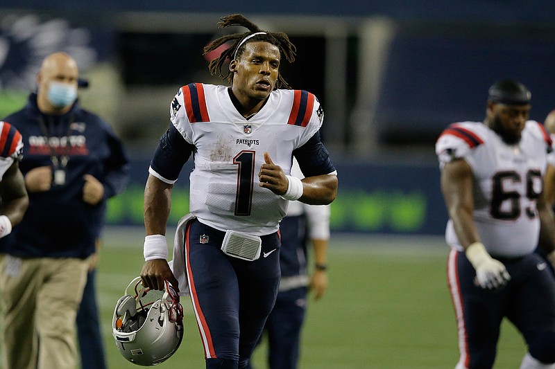 New England Patriots quarterback Cam Newton jogs off the field after an NFL football game against the Seattle Seahawks, Sunday, Sept. 20, 2020, in Seattle. The Seahawks won 35-30. (AP Photo/John Froschauer)