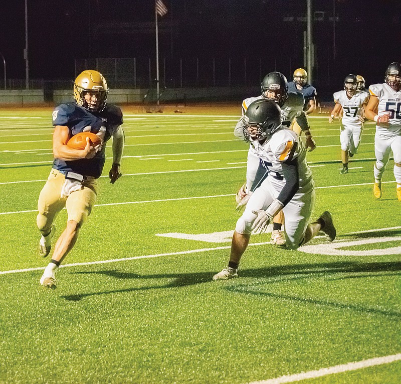 Helias quarterback Jacob Weaver runs for a touchdown against Sedalia Smith-Cotton late in the first half of Friday night's game at Ray Hentges Stadium.