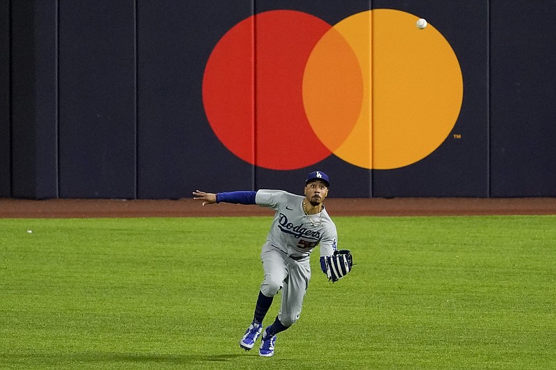 Dodgers right fielder Mookie Betts catches a fly ball hit by Dansby Swanson of the Braves during the third inning of Game 5 of the NLCS on Friday in Arlington, Texas. 