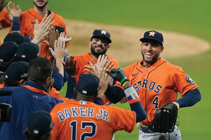 George Springer (4) and Jose Altuve celebrate with teammates after winning Friday's Game 6 of the ALCS in San Diego. The Astros defeated the Rays 7-4 to tie the series at 3.