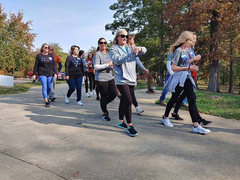 <p>Phillip Sitter/News Tribune</p><p style="text-align:right;">A group of people walk Saturday in Memorial Park in memory of Shaun Potter, who died by suicide in 2014. The walk was part of “Out of the Darkness” community events hosted by chapters of the American Foundation for Suicide Prevention.</p>