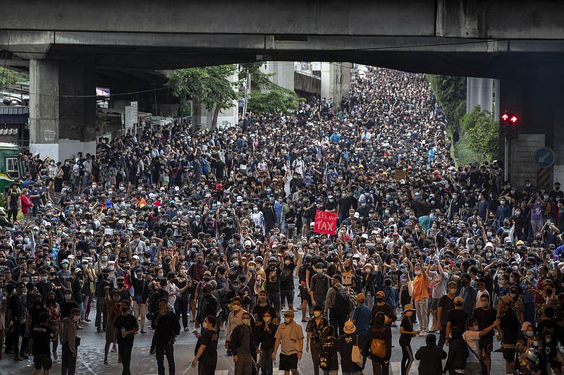 Pro-democracy protesters march during a protest in Udom Suk, suburbs of Bangkok, Thailand, Saturday, Oct. 17, 2020. The authorities in Bangkok shut down mass transit systems and set up roadblocks Saturday as Thailand’s capital faced a fourth straight day of determined anti-government protests. (AP Photo/Gemunu Amarasinghe)