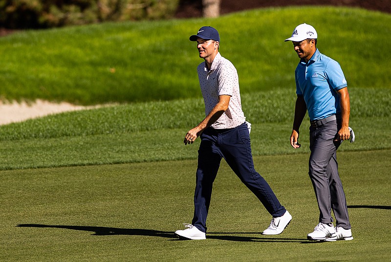 Russell Henley, left, talks with Xander Schauffele as they walk on the fairway at the 12th hole during the third round of the CJ Cup golf tournament at Shadow Creek Golf Course, Saturday, Oct. 17, 2020, in North Las Vegas. (Chase Stevens/Las Vegas Review-Journal via AP)