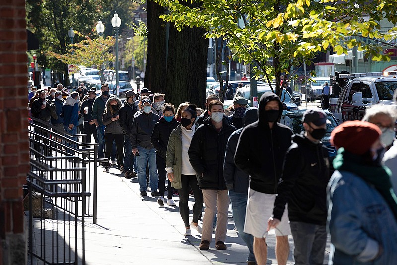 People wait in line to vote at Fenway Park, Saturday, Oct. 17, 2020, in Boston. (AP Photo/Michael Dwyer)