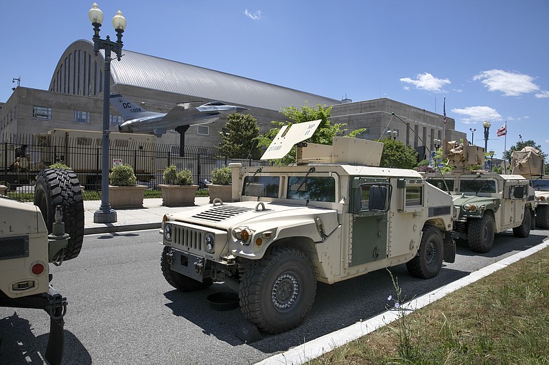 FILE - In this June 1, 2020, file photo, vehicles for the District of Columbia National Guard are seen outside the D.C. Armory in Washington. A peaceful protest in a sleepy suburb that's home to the head of the California National Guard was among four demonstrations monitored by National Guard spy planes. That's according to a report by the Los Angeles Times. The four spy planes took to the skies over cities in June to monitor protests following the killing of George Floyd. Three watched demonstrations in Minneapolis, Phoenix, and Washington, D.C. But the target of the fourth was the Sacramento, Calif., suburb of El Dorado Hills. (AP Photo/Jacquelyn Martin, File)