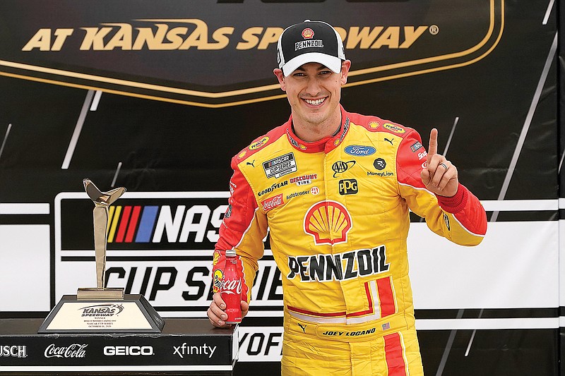 Joey Logano celebrates Sunday after winning the NASCAR Cup Series race at Kansas Speedway in Kansas City, Kan.