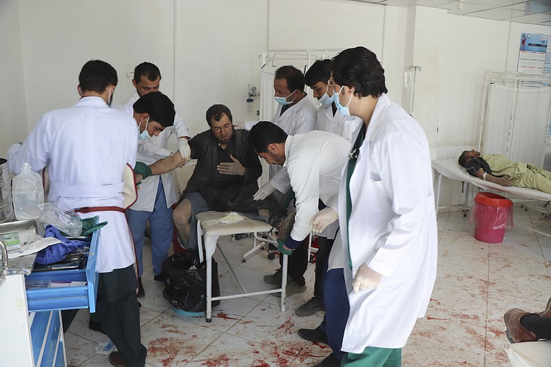 An Afghan receives a treatment at a hospital after a suicide car bombing in Ghor province western of Kabul, Afghanistan, Sunday, Oct. 18. 2020. A suicide car bombing on Sunday killed at least 1a dozen people and wounded more than 100 others in Afghanistan is western Ghor province officials said. (AP Photo)
