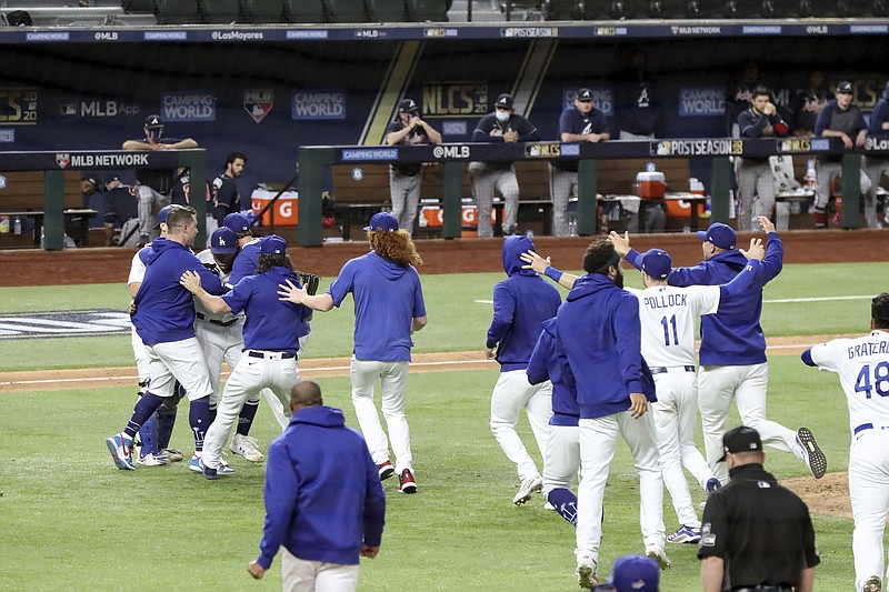 Dodgers players celebrate after Sunday night's win against the Braves to win the NLCS in Arlington, Texas.