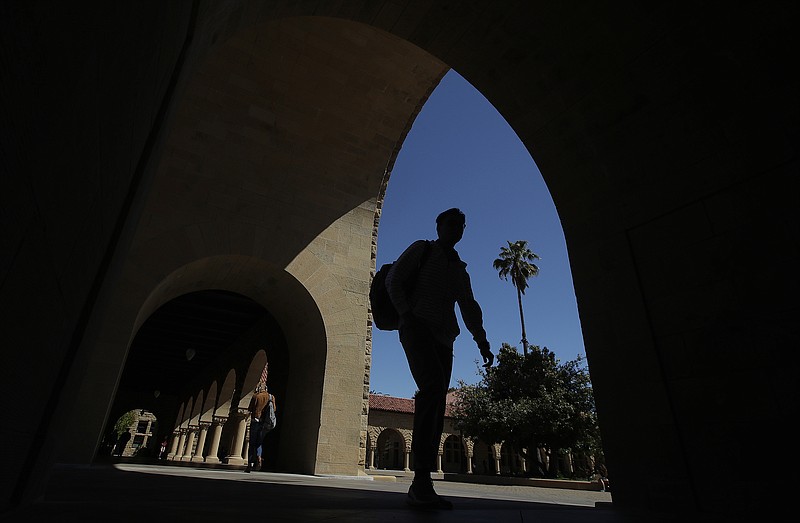 FILE - In this April 9, 2019, file photo, pedestrians walk on the campus at Stanford University in Stanford, Calif. (AP/Jeff Chiu, File)