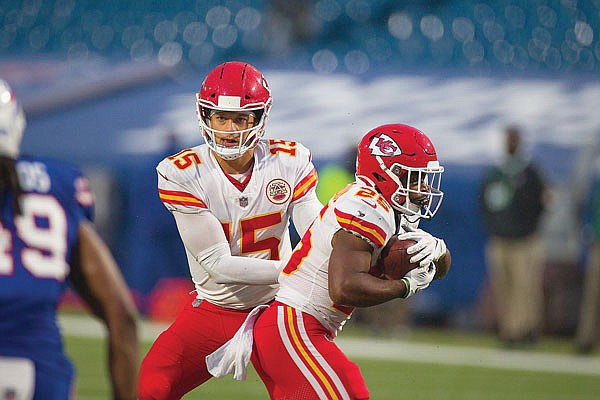 Chiefs quarterback Patrick Mahomes hands the ball to running back Clyde Edwards-Helaire during Monday's game against the Bills in Orchard Park, N.Y.