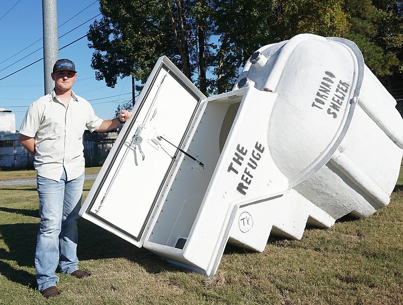 The "Refuge" being advertised and sold by Everett Plumbing in Atlanta, Texas, is a tornado shelter. That's employee Lane Kennedy holding the door open. There are numerous shelters around in Cass County, but none more elegant or seemingly indestructible.