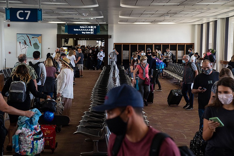 Many arriving passengers face long waits as state officials check to be sure all arrivals had answered a health questionnaire, had their temperatures taken and shown proof of a negative COVID test, at Honolulu International Airport on Thursday, Oct. 15, 2020, in Honolulu. (Kent Nishimura/Los Angeles Times/TNS)