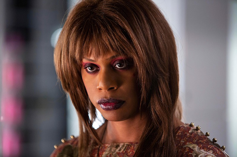 This image released by Hulu shows Laverne Cox in a scene from "Bad Hair," a comedy-horror about woman trying to rise in the late-80s music business who gets a demonic weave. The film premieres Friday on Hulu. (Tobin Yellan/Hulu via AP)