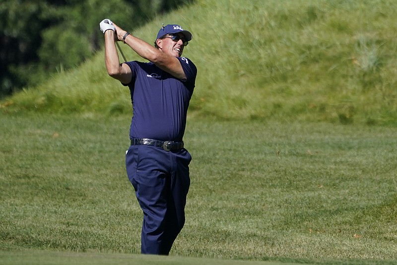 In this Aug. 20, 2020, file photo, Phil Mickelson hits from the rough on the 14th fairway in the first round of the Northern Trust at TPC Boston in Norton, Mass. 