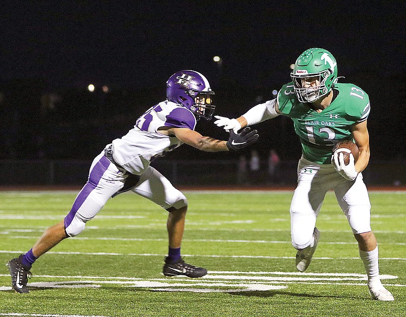 Blair Oaks wide receiver Carson Prenger pushes away Hallsville defensive back Ben Boyle as he runs toward the end zone for a touchdown during a game earlier this season at the Falcon Athletic Complex in Wardsville.