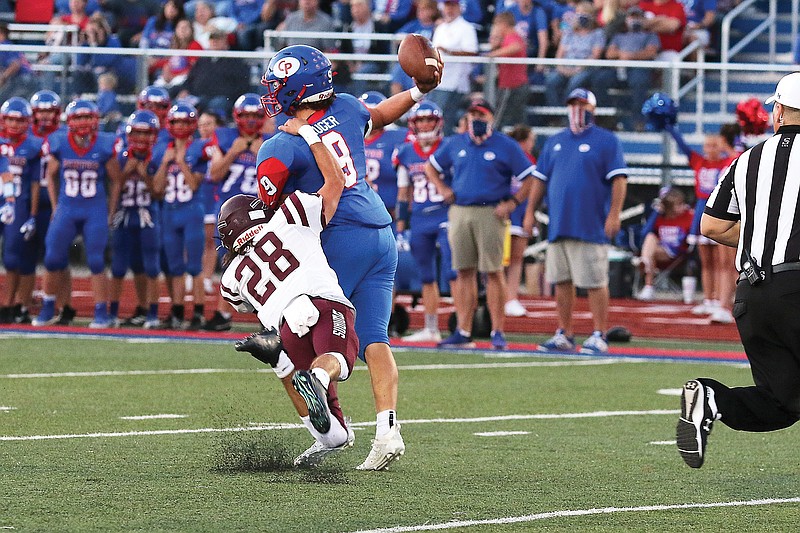 California quarterback Calen Kruger tries to throw the ball on the run while School of the Osage's Kenan Webb tries to tackle him during a game earlier this season in California.