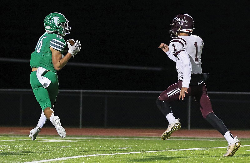 Blair Oaks receiver Jake Closser catches a pass downfield on his way to a touchdown with School of the Osage defensive back Konner Vaughn trailing on the play during Friday night's game at the Falcon Athletic Complex in Wardsville.