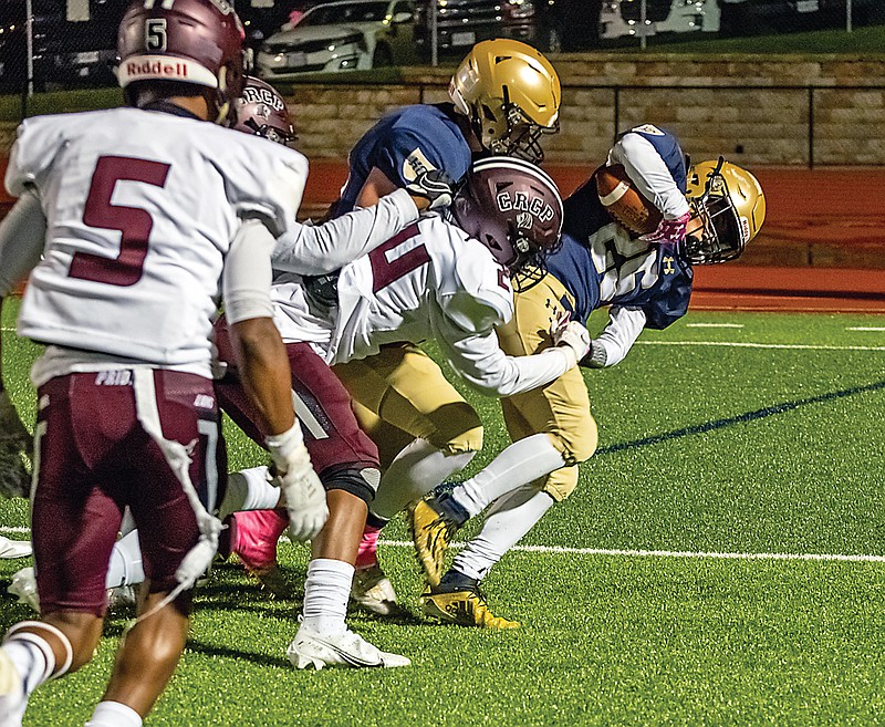 Helias running back Ryan Klahr breaks several tackles on his way to a touchdown Friday night against Cardinal Ritter at Ray Hentges Stadium.  