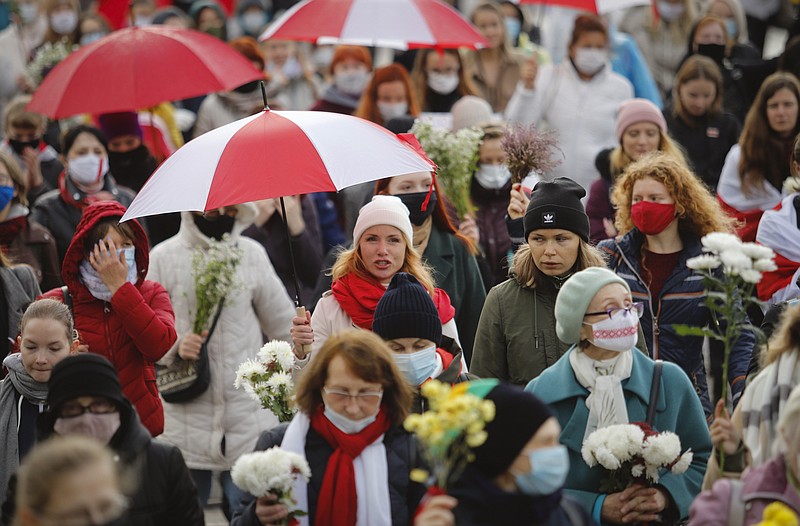 Belarusian women with umbrellas in the colors of the old Belarusian national flag take part in an opposition rally to protest the official presidential election results in Minsk, Belarus, Saturday, Oct. 24, 2020. Several hundred women have marched under heavy rain across the Belarusian capital to demand the resignation of the country’s authoritarian president. (AP Photo)