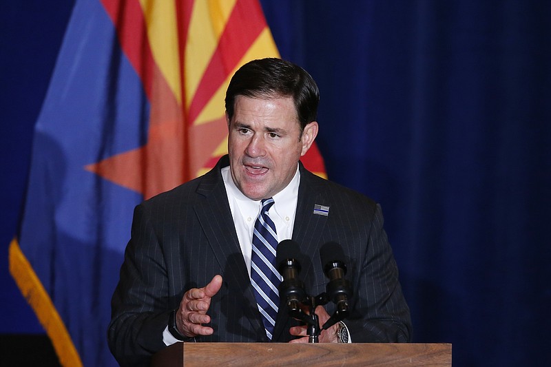 FILE - In this Tuesday, Aug. 11, 2020, file photo, Republican Arizona Gov. Doug Ducey speaks prior to Vice President Mike Pence speaking at the "Latter-Day Saints for Trump" Coalition launch event in Mesa, Ariz. Republicans have criticized a push by some Democrats to expand the number of seats on the U.S. Supreme Court, but their tune has changed when it comes to the highest courts at the state level. In 2016, Ducey signed into law measures expanding the number of seats on the Arizona state Supreme Court. (AP Photo/Ross D. Franklin, File)