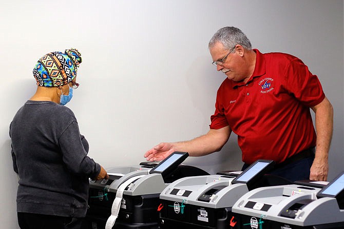 Patsy Galbreath-Johnson and Cole County Clerk Steve Korsmeyer make sure the voting machines for Cole County are correctly counting votes on Thursday, Oct. 22, 2020.