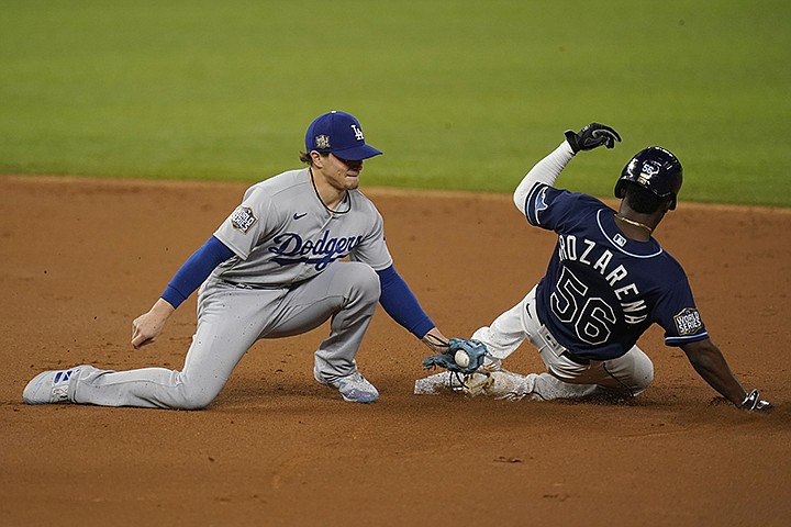 Tampa Bay Rays' Randy Arozarena gets tagged out stealing by Los Angeles Dodgers second baseman Enrique Hernandez during the first inning in Game 4 of the baseball World Series Saturday, Oct. 24, 2020, in Arlington, Texas. (AP Photo/Eric Gay)