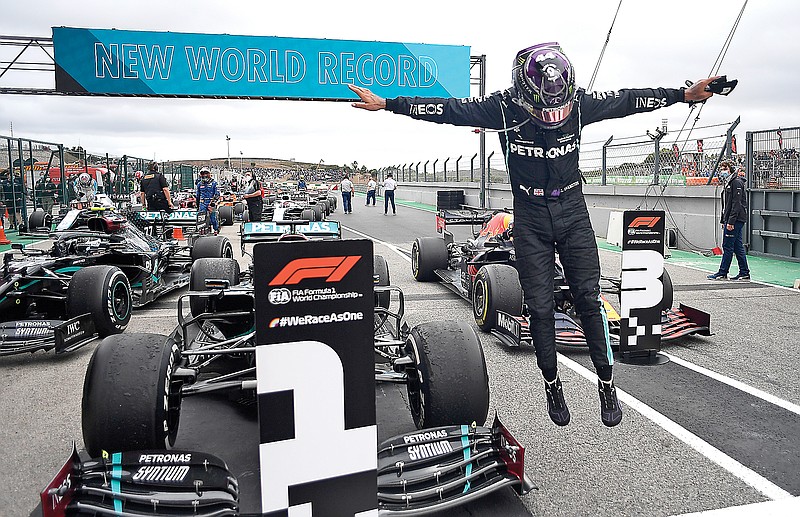Lewis Hamilton jumps out of his car Sunday after his record-breaking 92nd Formula One career win at the Portuguese Grand Prix at the Algarve International Circuit in Portimao, Portugal.