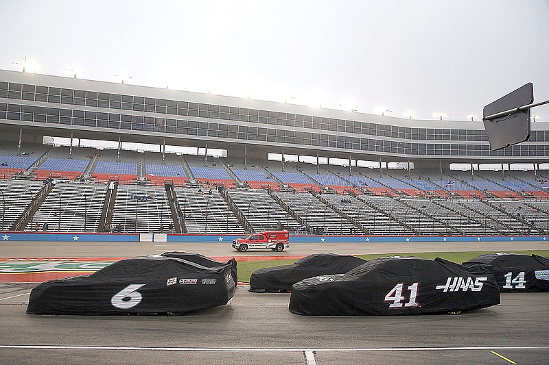 Cars sit on pit road during a red flag period due to misty rain during a NASCAR Cup Series race Sunday at Texas Motor Speedway in Fort Worth, Texas.