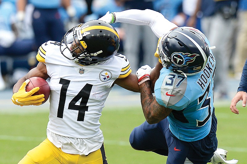 Titans safety Amani Hooker tries to bring down Steelers wide receiver Ray-Ray McCloud in the first half of Sunday afternoon's game in Nashville, Tenn.