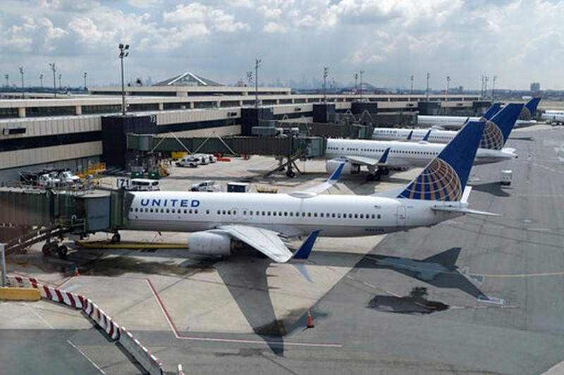 In this Wednesday, July 1, 2020 file photo, United Airlines planes are parked at gates at Newark Liberty International Airport in Newark, N.J. A nonprofit software developer is testing a smartphone app and data framework that could make it easier for international airline passengers to securely show they've complied with COVID-19 testing requirements. It's an attempt to help get people back to flying after the pandemic sent global air travel down by 92%. The Switzerland-based Commons Project Foundation was conducting a test Wednesday, Oct 21 of its CommonPass digital health pass on United Airlines Flight 15 from London's Heathrow to Newark Liberty International Airport, using volunteers carrying the app on their smartphones. 