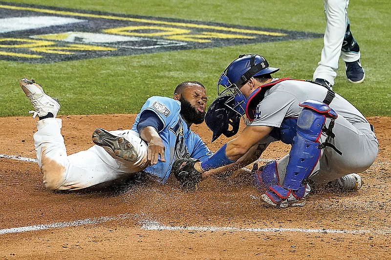 Manuel Margot of the Rays is tagged out by Dodgers catcher Austin Barnes trying to steal home during the fourth inning Sunday in Game 5 of the World Series in Arlington, Texas. The Dodgers won the game 4-2 to take a 3-2 lead in the series.