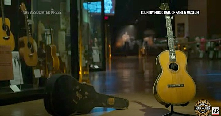 This screenshot of an Associated Press video shows several historic and rare instruments on display at the Country Music Hall of Fame in Nashville, Tenn. After taking a financial hit due to COVID-19, the Country Music Hall of Fame and Museum turned to its collection of historic and rare instruments for help. The museum, which is looking at $35 million in lost revenue, is holding a virtual fundraising concert with instruments owned by Johnny Cash, Loretta Lynn and Maybelle Carter. The Big Night at the Museum event will be live on YouTube at 8 p.m. Wednesday. Associated Press