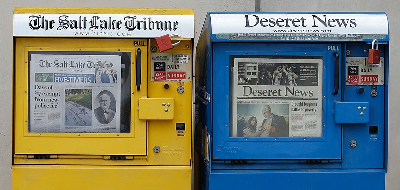 The Salt Lake Tribune and Deseret News newspaper boxes await customers on June 16, 2014, in Salt Lake City. The capital of Utah will go from two daily printed newspapers to none after both Salt Lake City's major publications moved to weekly print schedules in the last two days. The 170-year-old Deseret News said it will stop publishing daily starting next year in an announcement Tuesday, Oct. 27, 2020, a day after the Salt Lake Tribune made a similar announcement. The two publications' joint-operating agreement will also end at the end of the year. (AP Photo/Rick Bowmer, File)
