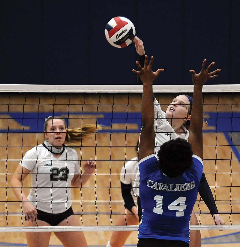 Cate Albertson of Helias slams the ball over the net as Michelyn Appiah of Capital City goes for the block Tuesday during the Class 5 District 9 Tournament at Capital City High School.