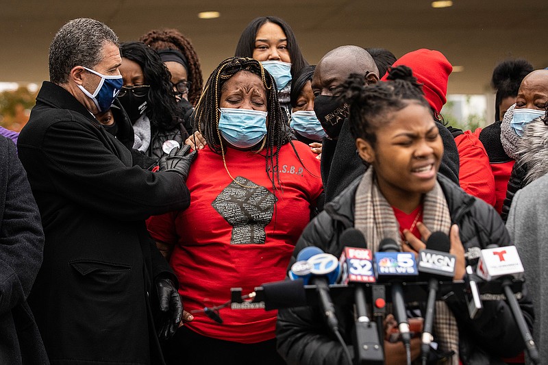 Clifftina Johnson (back, left), Tafara Williams' mother, cries as her daughter, Sasha Williams, sings during a press conference outside city hall in Waukegan, Ill., Tuesday, Oct. 27, 2020. Williams, 20, was wounded and her boyfriend, 19-year-old Marcellis Stinnette, was killed when they were both shot by a Waukegan police officer on Oct. 20. Three days after the incident, Waukegan Police Chief Wayne Walles announced that he had fired the officer, saying he'd committed "multiple policies and procedure violations." (Ashlee Rezin Garcia/Chicago Sun-Times via AP)