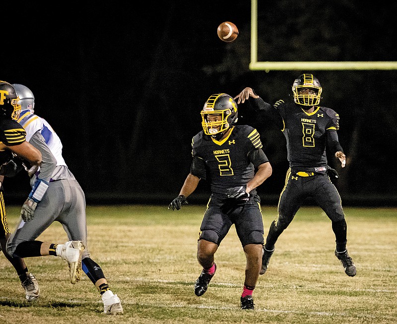 Fulton quarterback Courtland Simmons throws a pass while running back Tyreion Logan blocks in front of him during last Friday night's game against Sweet Springs at Robert E. Fisher Stadium in Fulton.