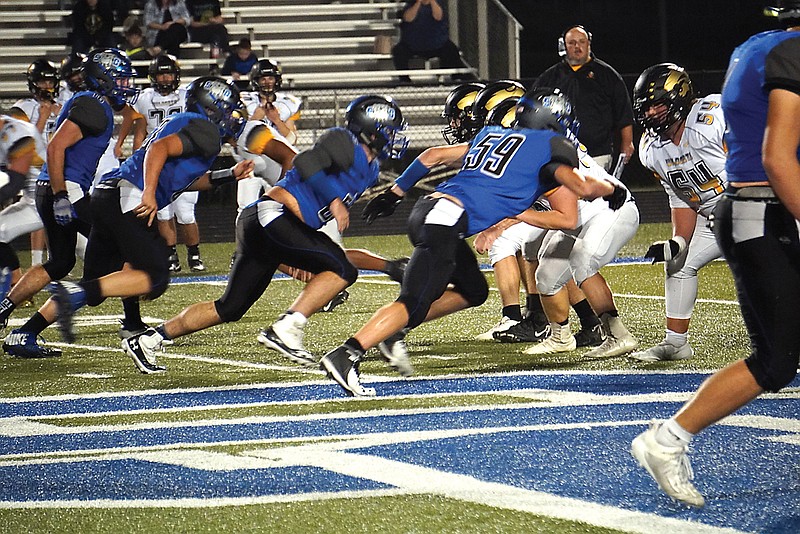 South Callaway's defensive line rushes the Cuba offense during a game earlier this month in Mokane.