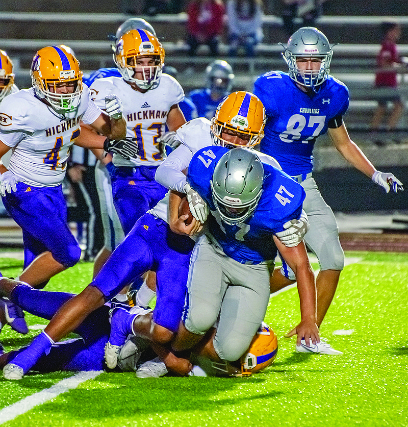 Capital City's Hurley Jacobs keeps a tight grasp on the ball while getting tackled during a game earlier this season against Hickman at Adkins Stadium. 