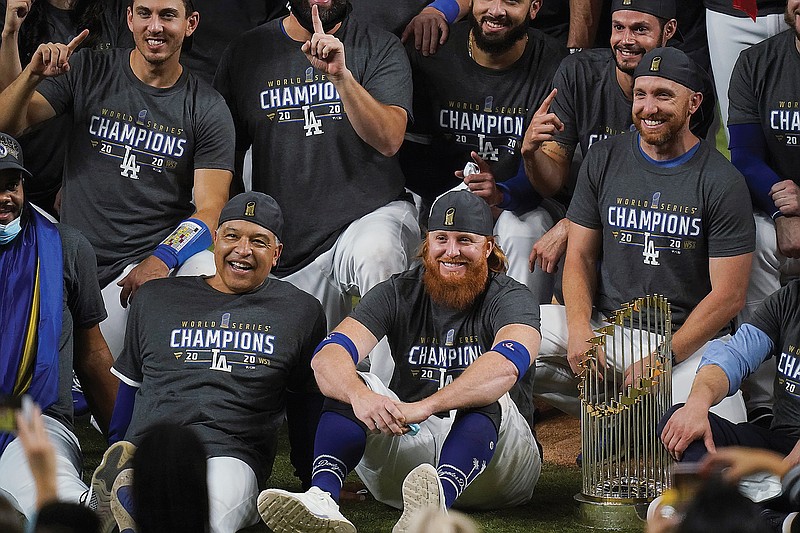 Dodgers manager Dave Roberts and third baseman Justin Turner pose for a group picture Tuesday after the Dodgers defeated the Rays in Game 6 to win the World Series in Arlington, Texas.