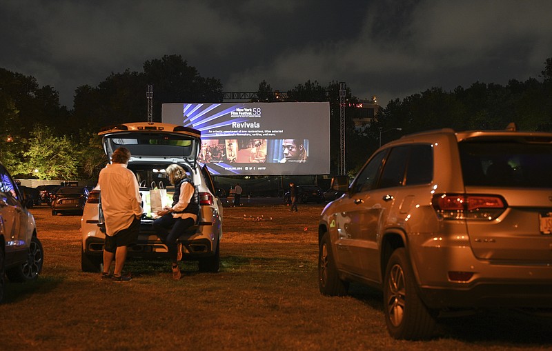 FILE - Filmgoers attend the "Nomadland" screening at the Queens Drive-In at the New York Hall of Science during the 58th New York Film Festival in New York on Sept. 26, 2020. After a historic season, winter is coming at the drive-in. Summer and early fall have seen the old drive-in transformed into a surprisingly elastic omnibus of pandemic-era gathering. Red-carpet premieres that would normally consume Lincoln Center uprooted to drive-ins. (Photo by Evan Agostini/Invision/AP, File)