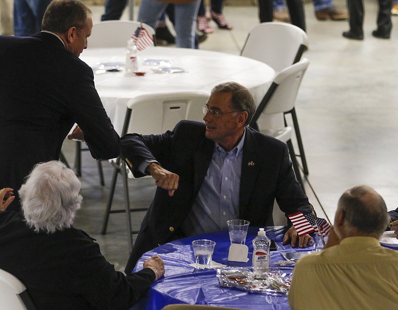Sen. Blaine Luetkemeyer, R-MO, bumps elbows with a supporter during his election watch party on Tuesday at Capital Bluffs Event Center.
