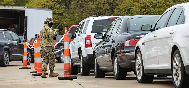 Julie Smith/News Tribune
PFC Laura Adams of the 206th Area Support Medical Company in Springfield directs traffic as people wait in line for testing. Members of the Missouri Army National Guard are continuing to facilitate community Covid-19 testing , including a stop in Jefferson City Tuesday, Oct. 27, at the First Assembly of God Church on Rt. C.