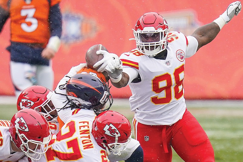 Chiefs defensive tackle Tershawn Wharton forces a fumble against Broncos running back Melvin Gordon during a gamelast month in Denver. 