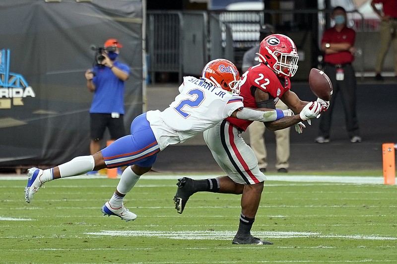 Florida defensive back Brad Stewart Jr. (2) breaks up a pass intended for Georgia running back Kendall Milton (22) during the first half of Saturday's game in Jacksonville, Fla.