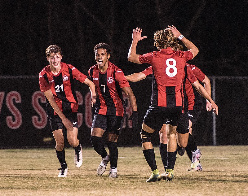 Jefferson City's Bassil Ahmed (7) celebrates with teammates, including Quinn Walker (21) and Logan Barger (8), after scoring the opening goal against Blue Springs in the first half of Saturday night's Class 4 sectional game at Eddie Horn Field.